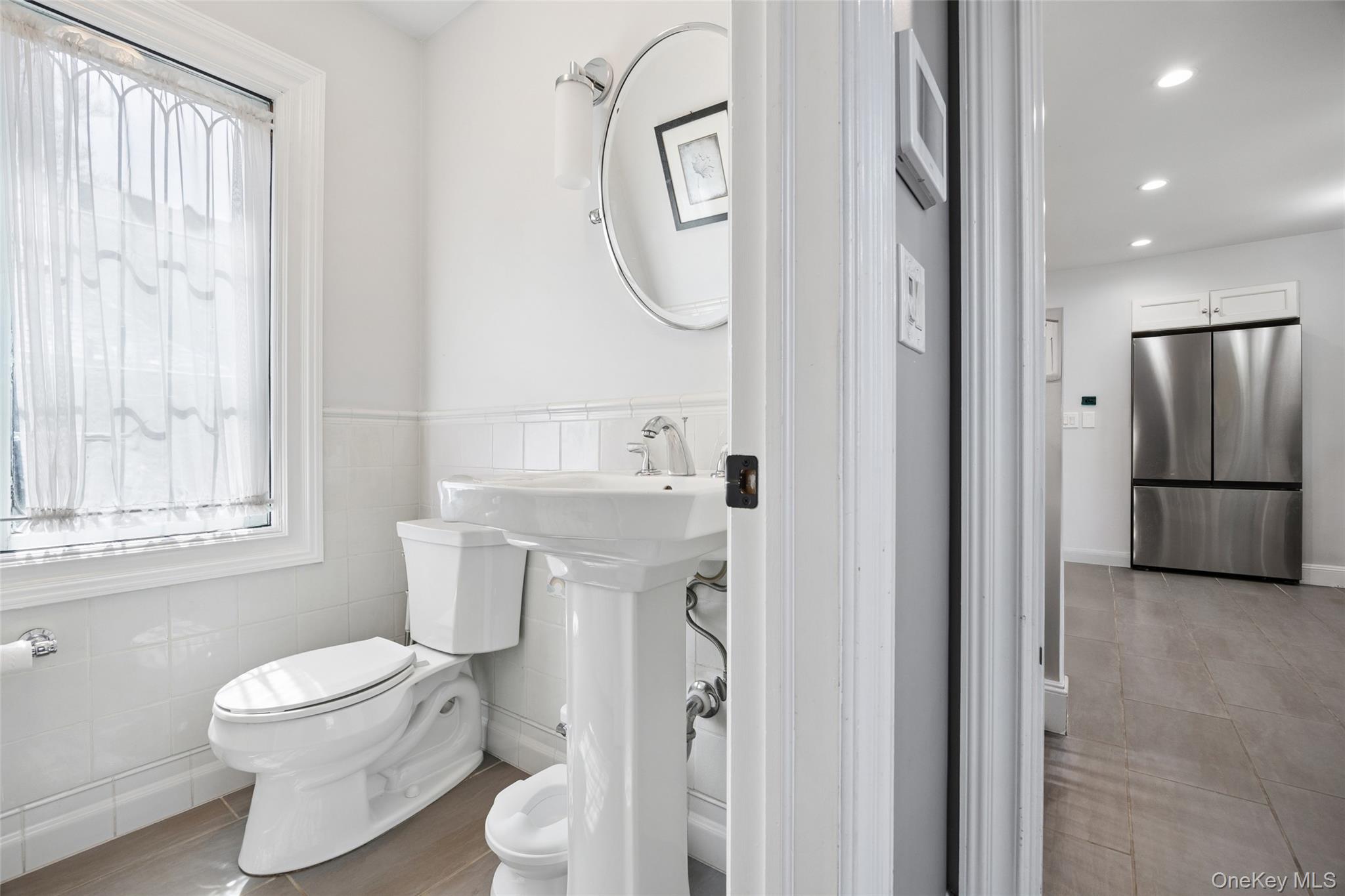 216 Beverly Road Queens, NY 11363 - Photo 4 of 50 a bathroom with a toilet sink and shower