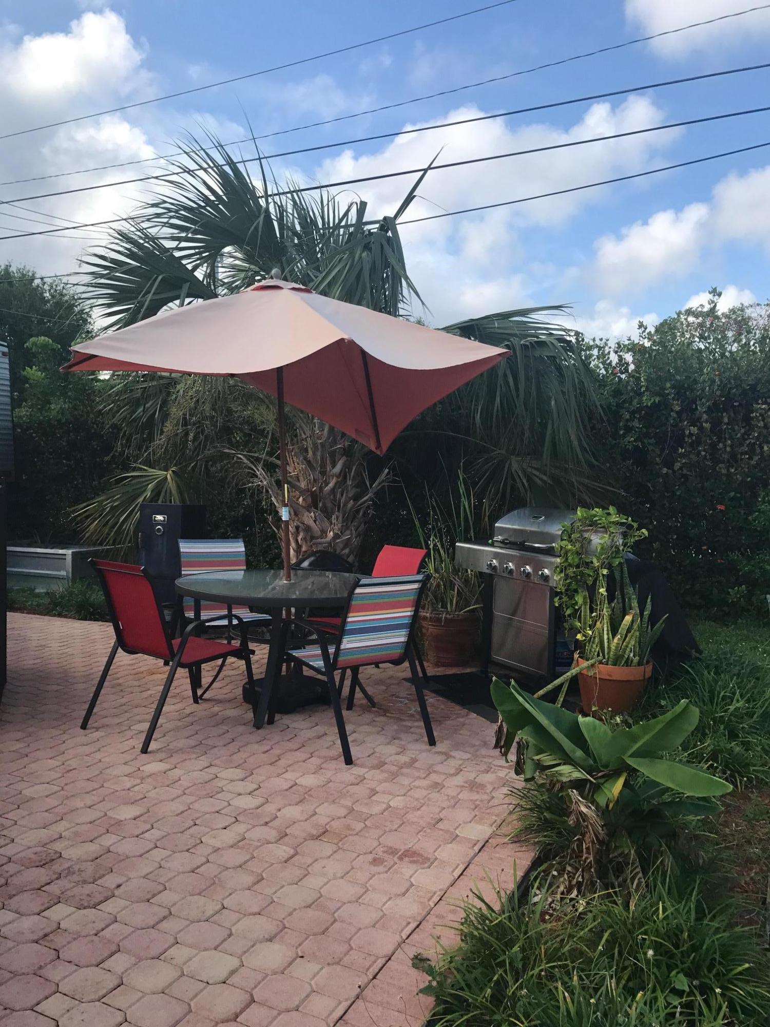 1299 Southwest 4th Street Boca Raton, FL 33486 - Photo 12 of 34 a backyard of a house with table and chairs