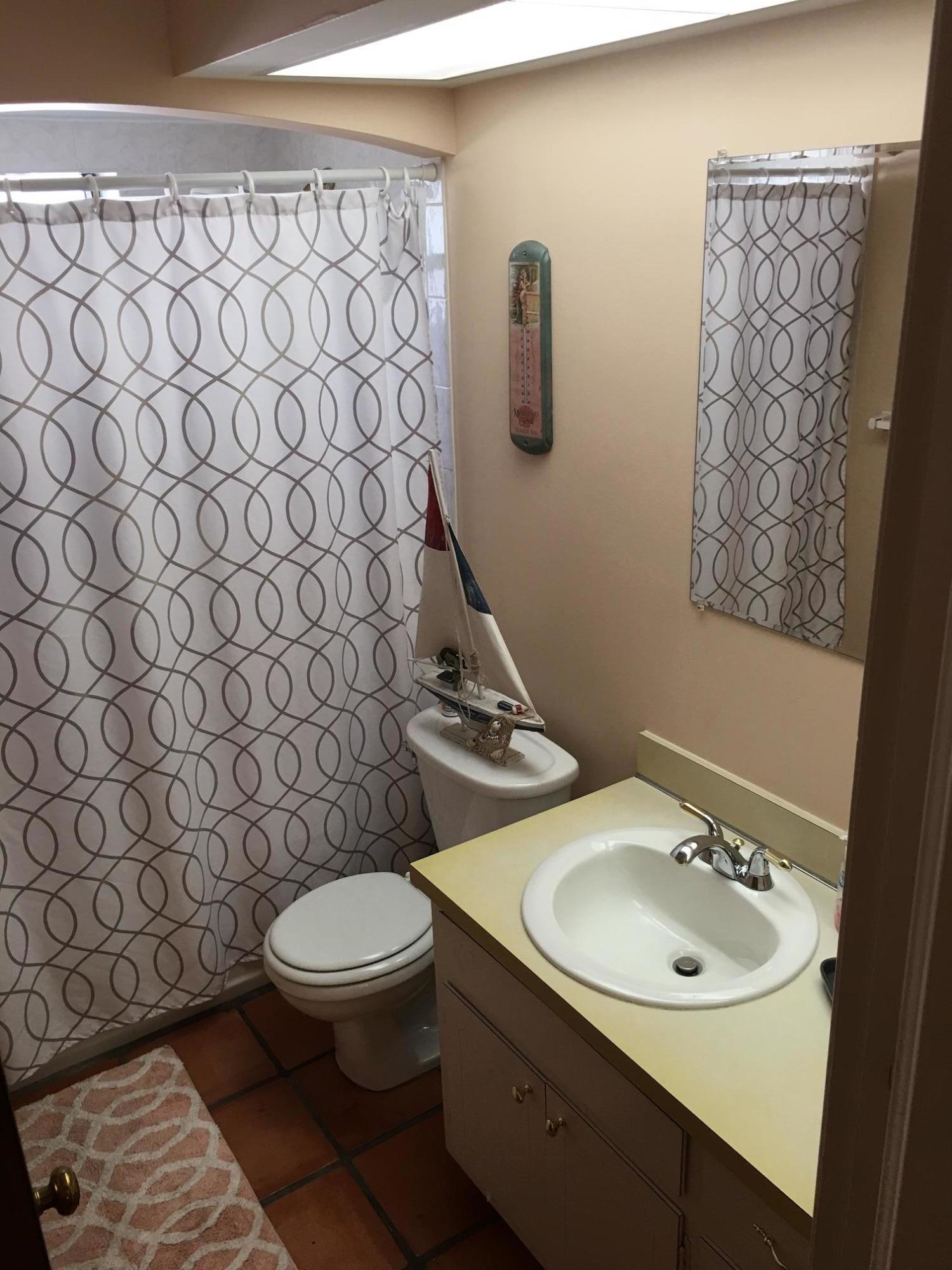 1299 Southwest 4th Street Boca Raton, FL 33486 - Photo 34 of 34 a bathroom with a sink and a toilet