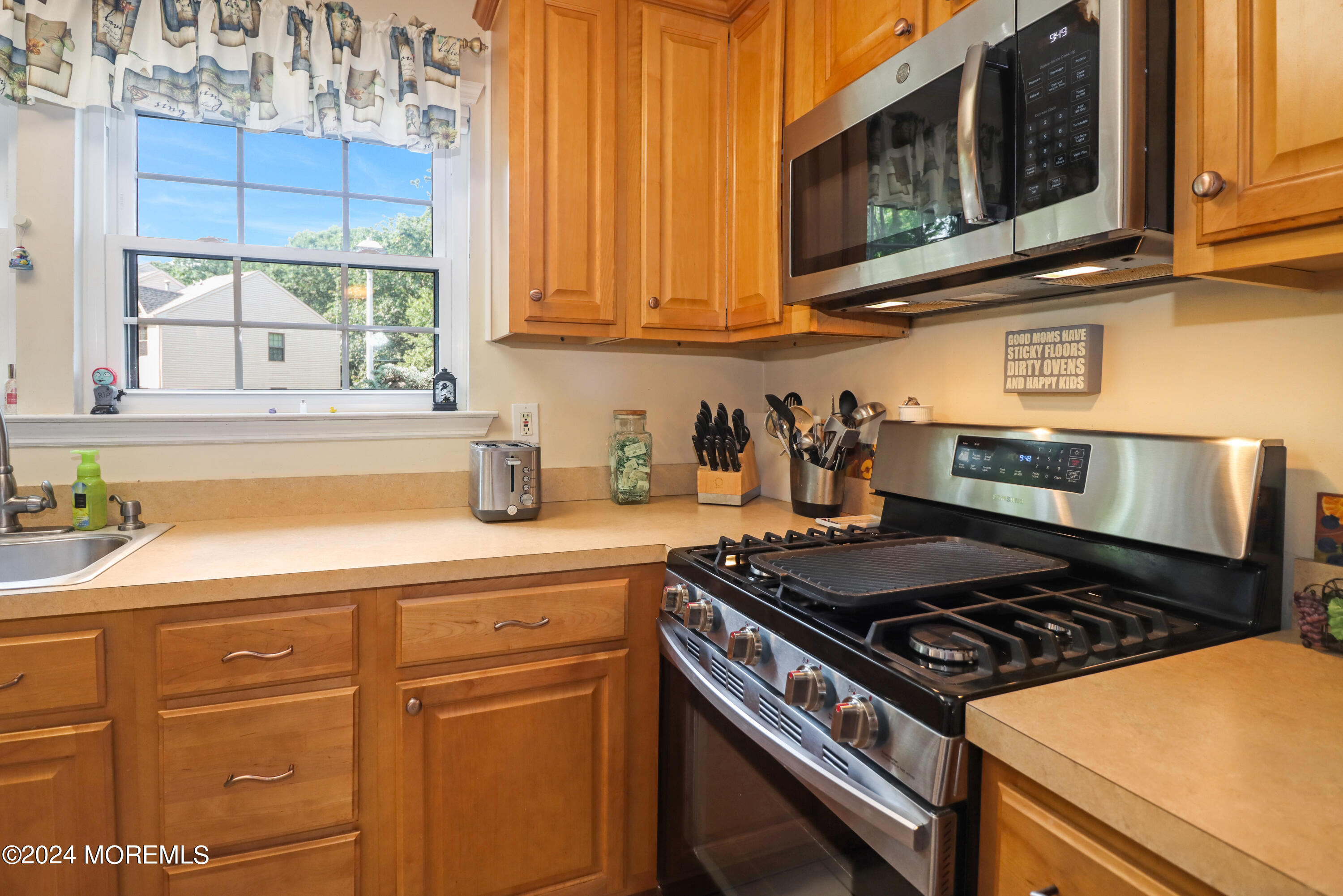100 Whispering Oaks Way Jackson, NJ 08527 - Photo 16 of 56 a kitchen with stainless steel appliances granite countertop a stove and a sink