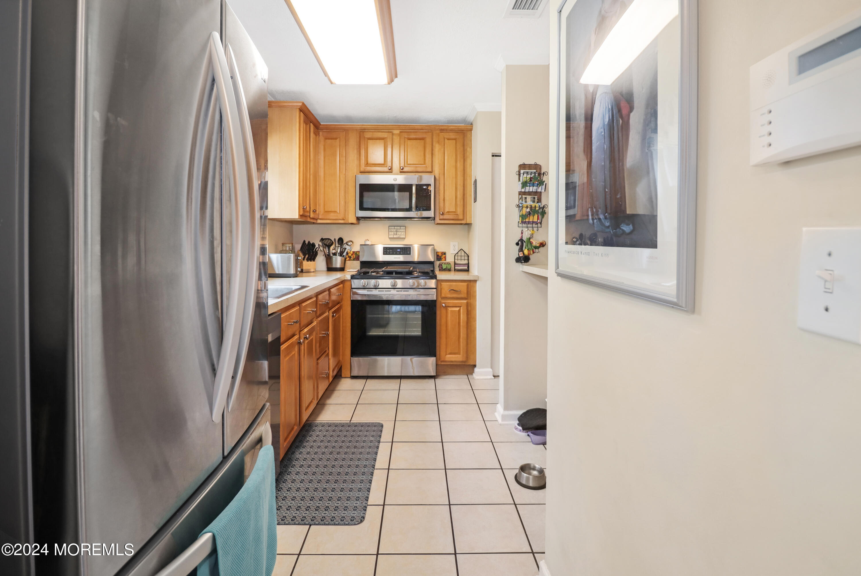 100 Whispering Oaks Way Jackson, NJ 08527 - Photo 18 of 56 a kitchen with stainless steel appliances granite countertop a refrigerator and a stove