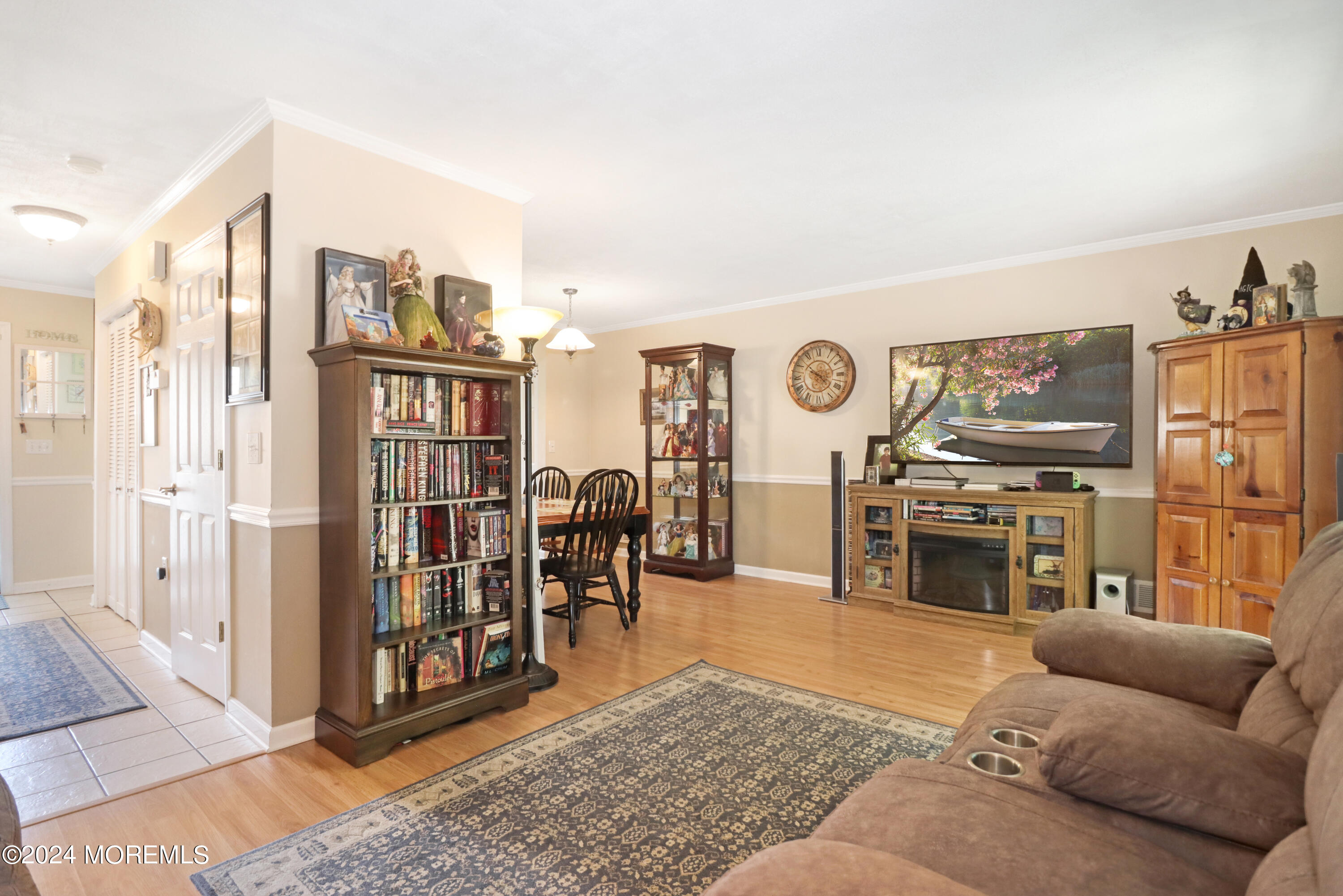 100 Whispering Oaks Way Jackson, NJ 08527 - Photo 24 of 56 a living room with furniture a fireplace and a flat screen tv