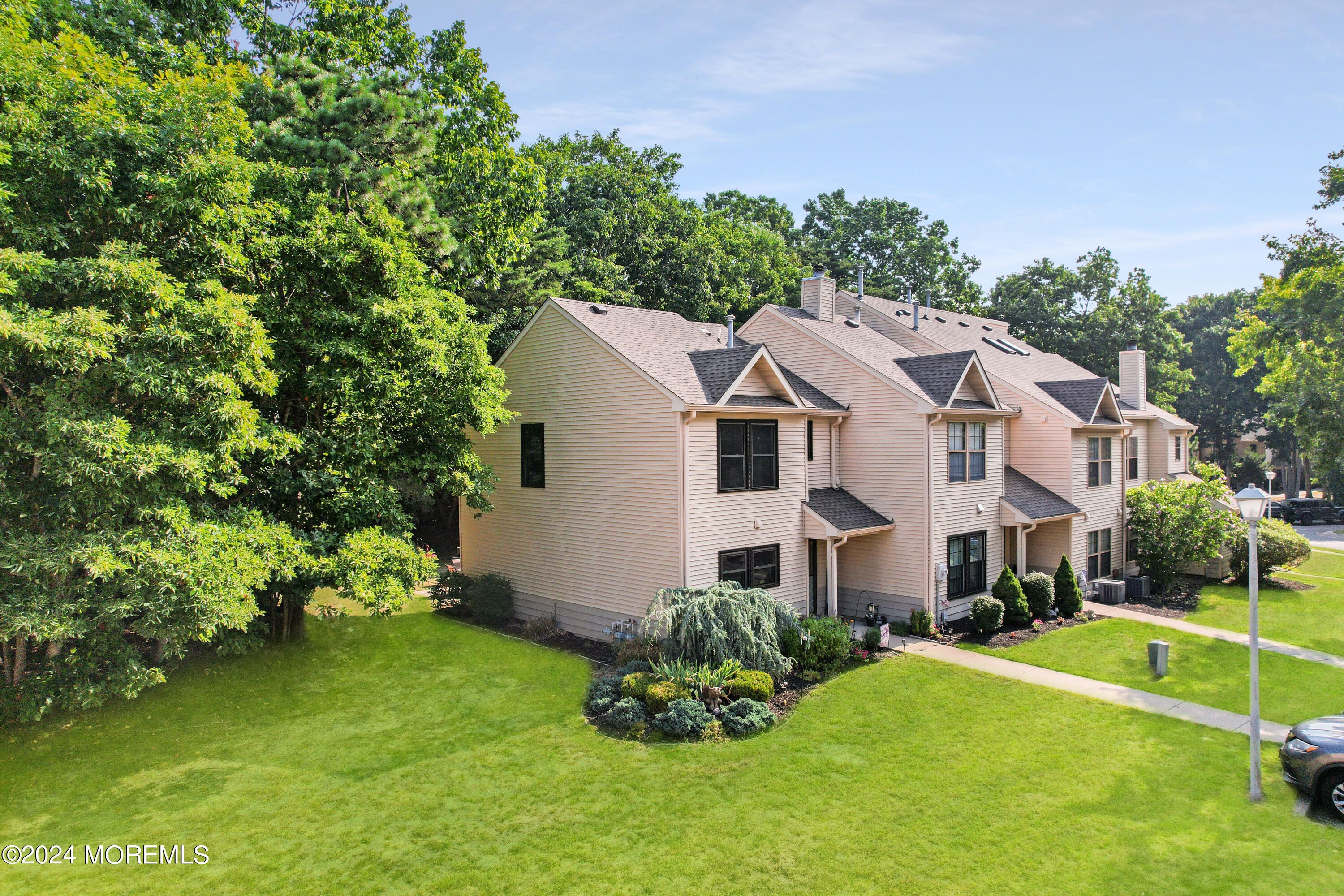 100 Whispering Oaks Way Jackson, NJ 08527 - Photo 3 of 56 a aerial view of a house with a yard table and chairs