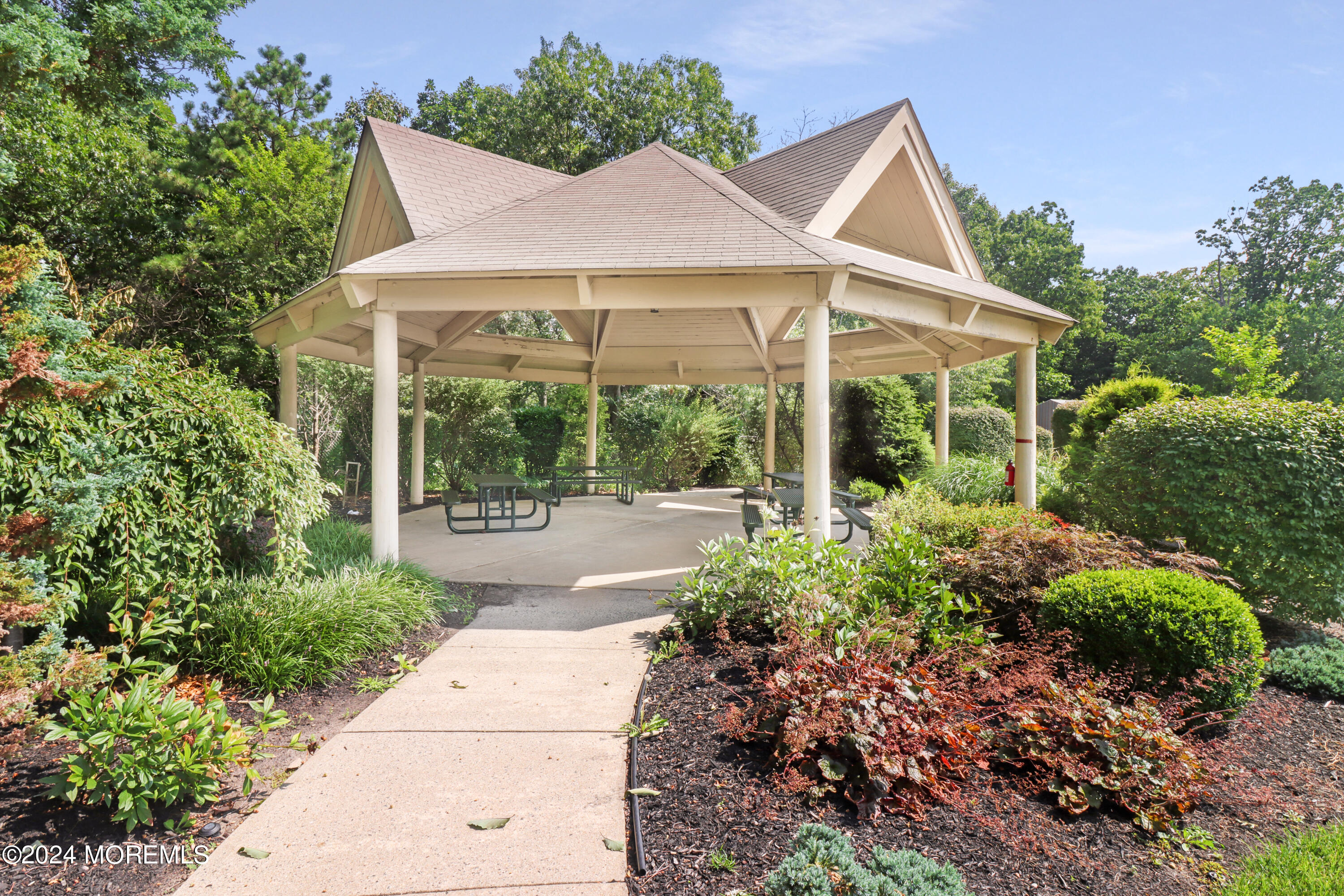 100 Whispering Oaks Way Jackson, NJ 08527 - Photo 44 of 56 a view of a patio with table and chairs under an umbrella
