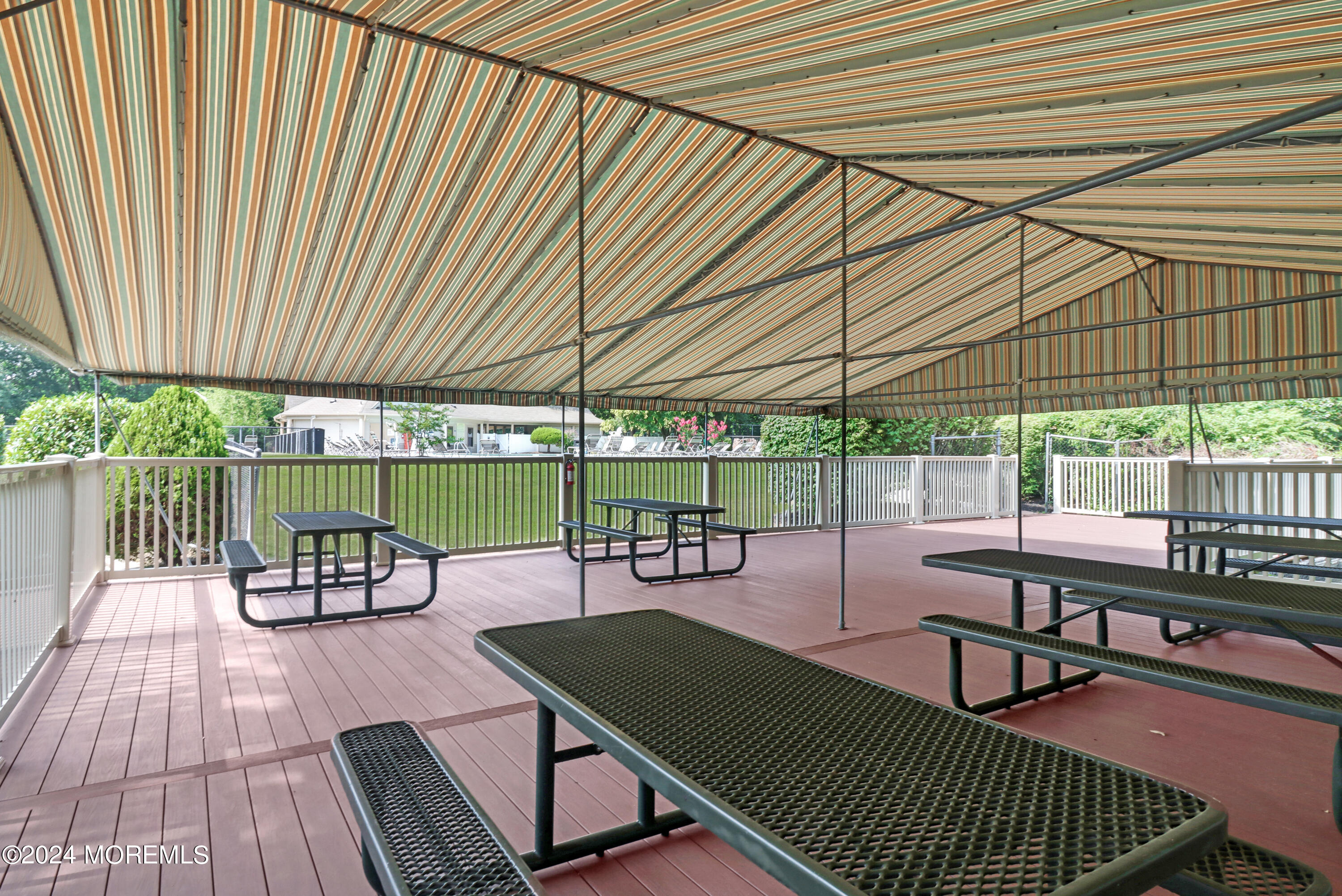 100 Whispering Oaks Way Jackson, NJ 08527 - Photo 51 of 56 a view of a patio with a table chairs and a barbeque