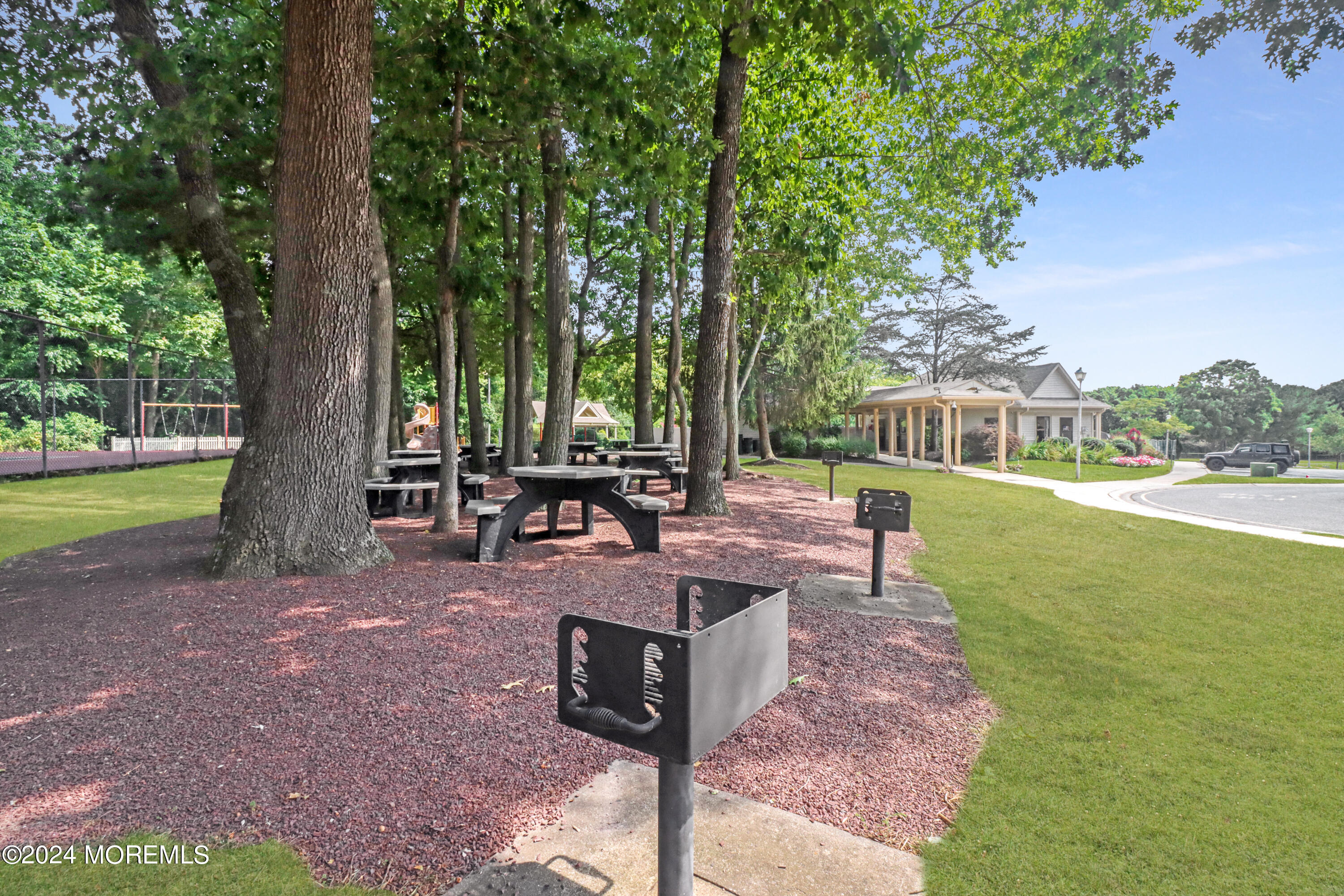 100 Whispering Oaks Way Jackson, NJ 08527 - Photo 53 of 56 a view of a backyard with a garden and sitting area