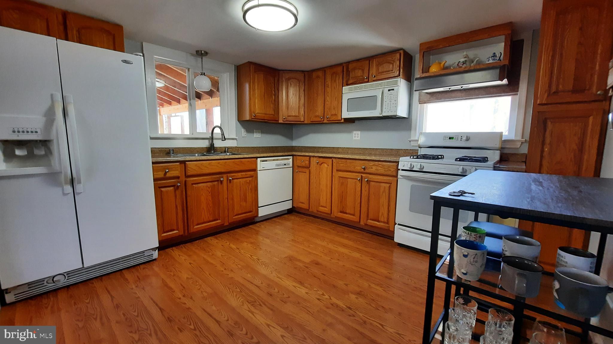 2478 High Top Road Linden, VA 22642 - Photo 12 of 36 a kitchen with stainless steel appliances granite countertop wooden cabinets a stove a sink and a refrigerator