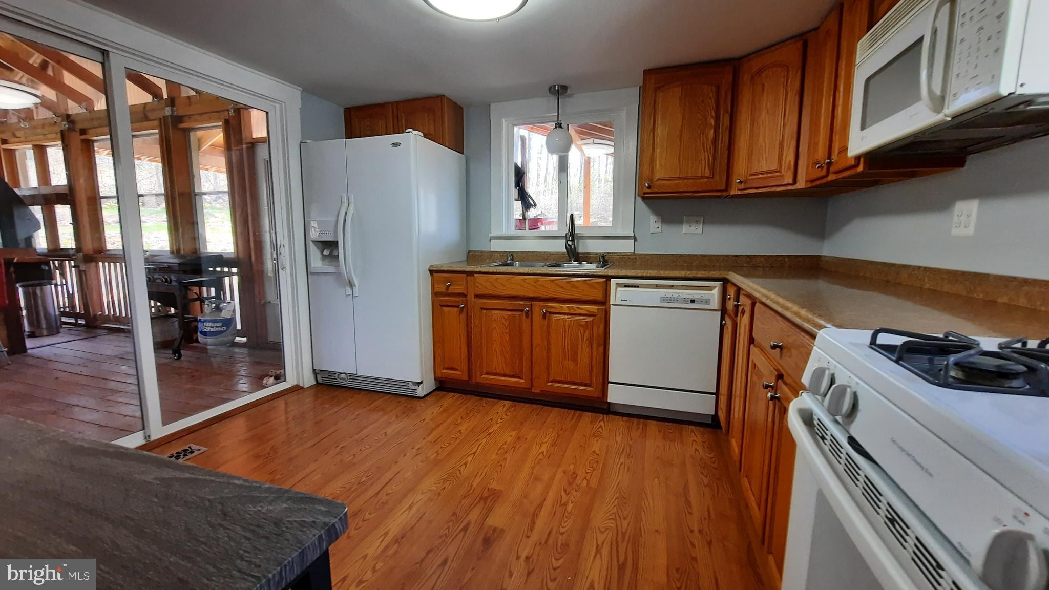 2478 High Top Road Linden, VA 22642 - Photo 13 of 36 a kitchen with stainless steel appliances granite countertop a refrigerator a stove a sink and dishwasher with wooden floor