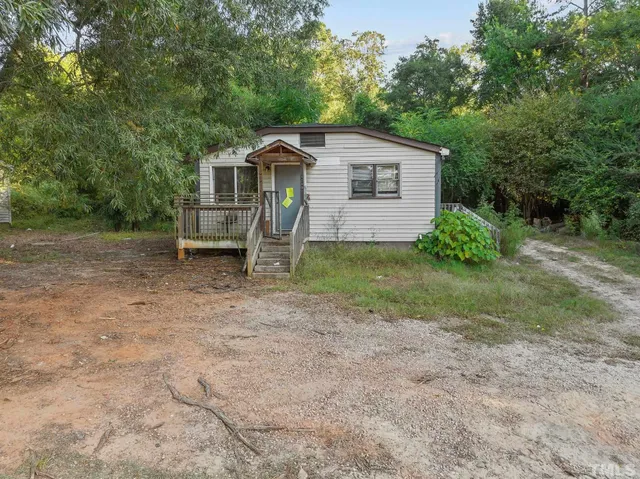 a view of a house with a tree in the background