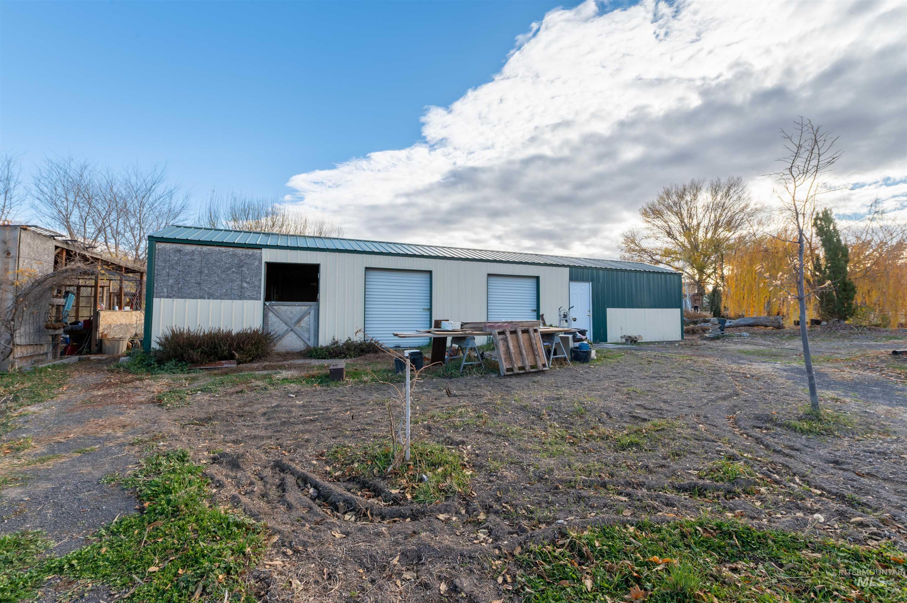 408 Clear Lakes Road Buhl, ID 83316 - Photo 10 of 16 Rear view of house featuring an outbuilding and a metal roof