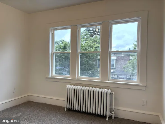 an empty room with a empty space and windows