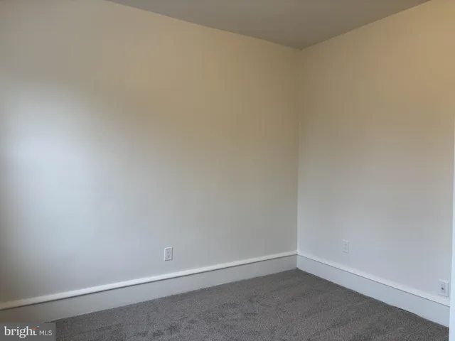 a view of an empty room with closet area