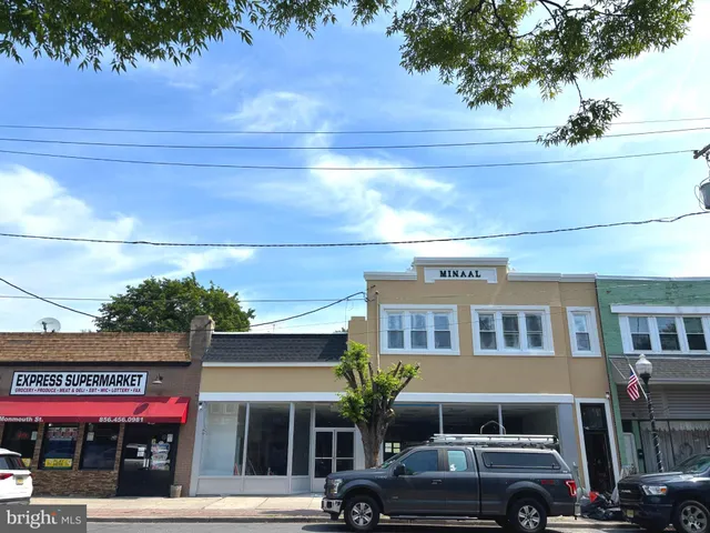 a front view of a building with car parked
