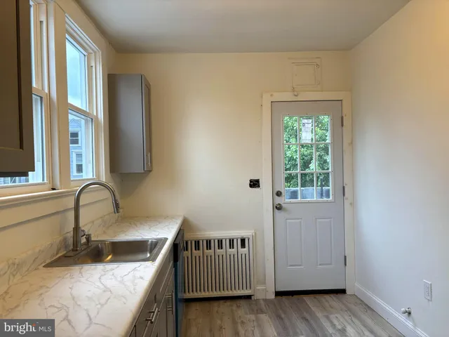 a kitchen with stainless steel appliances a stove a refrigerator and a sink with wooden cabinets