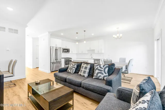 a living room with furniture and kitchen view