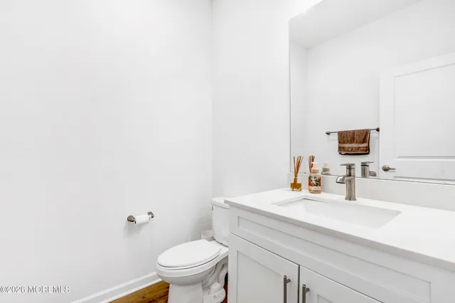 a bathroom with a sink a toilet and mirror