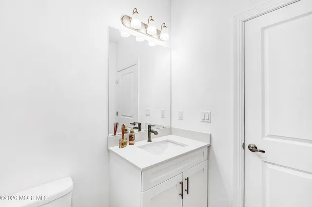 a bathroom with a sink vanity and a mirror