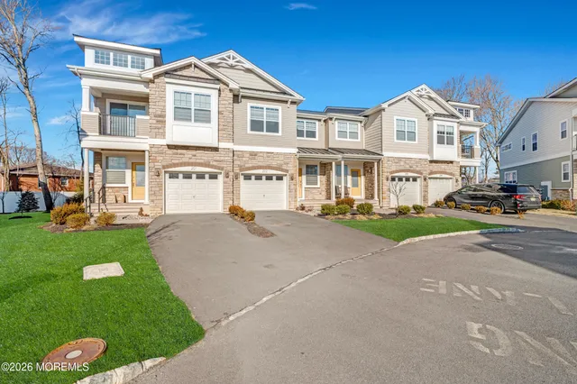 a front view of a residential apartment building with a yard
