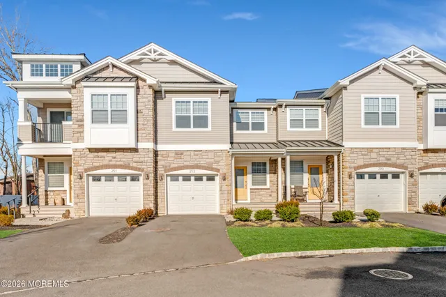 a front view of a house with a garden and garage