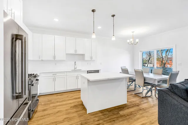 a kitchen with a sink cabinets and wooden floor