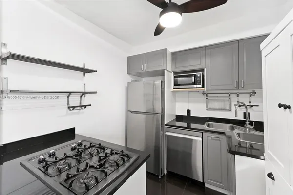 a kitchen with a stove and a refrigerator