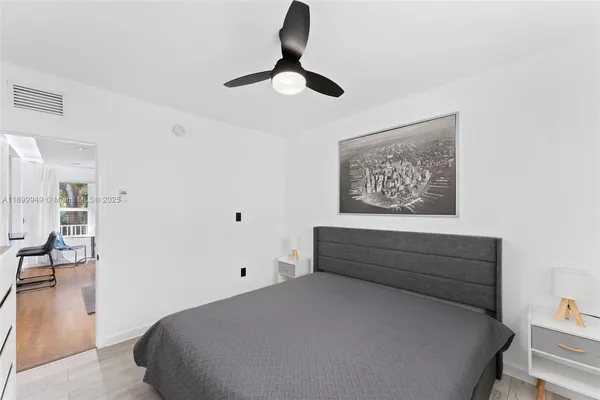 a view of a livingroom with a ceiling fan & entryway