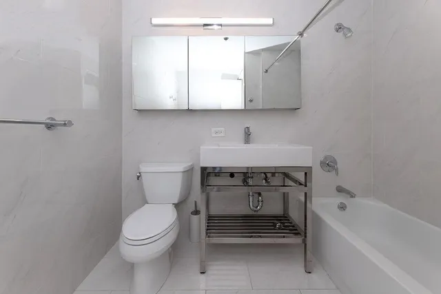 a bathroom with a sink a toilet and bathtub