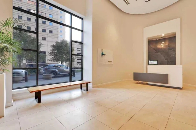 a view of lobby with a floor to ceiling window and a rug