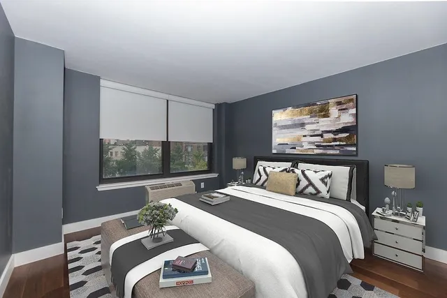 a bedroom with bed and a flat screen tv