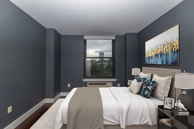 a bedroom with a bed and a window