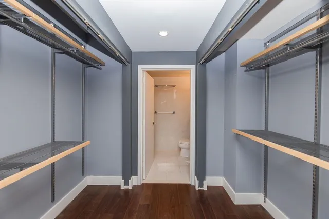 a view of hallway with stairs and wooden floor