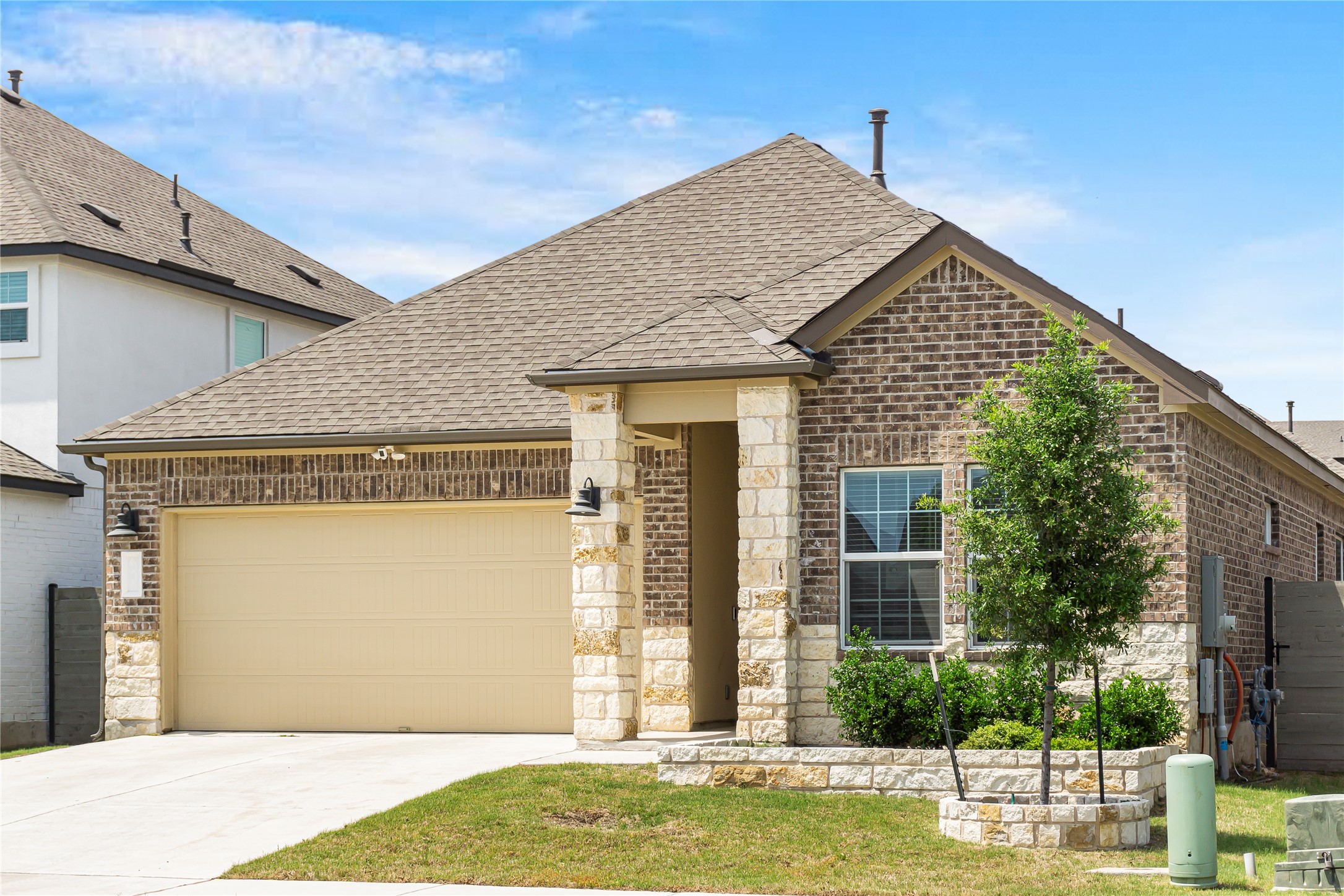 124 Cherry Ridge Road Georgetown, TX 78628 - Photo 2 of 23 Brick and stone veneer exterior with a two-car garage