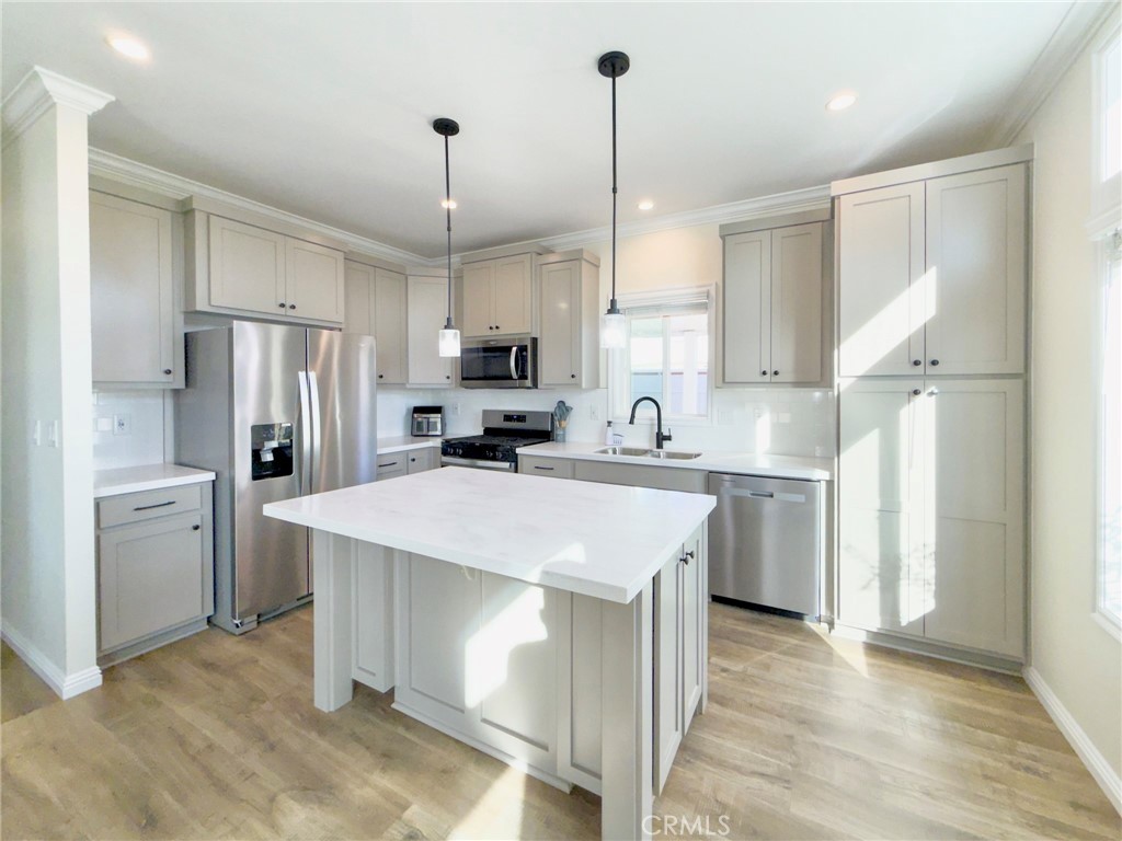 12530 Royal Road, Unit 46 El Cajon, CA 92021 - Photo 2 of 17 a kitchen with white cabinets and stainless steel appliances