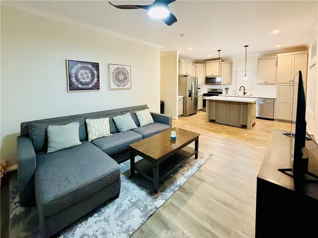 a living room with furniture and kitchen view