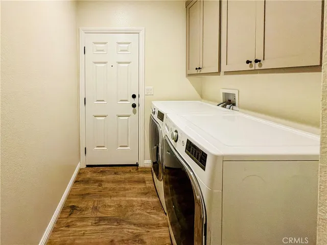 a bathroom with a sink a toilet a mirror and shower