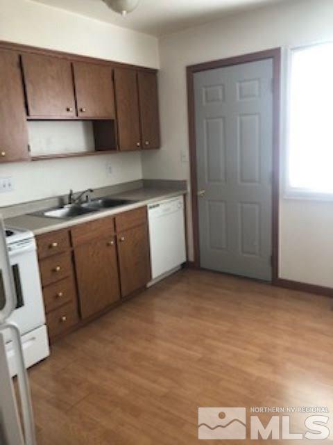 1408 East 9th Street, Unit 2 Reno, NV 89512 - Photo 2 of 10 a kitchen with granite countertop a sink a stove and cabinets