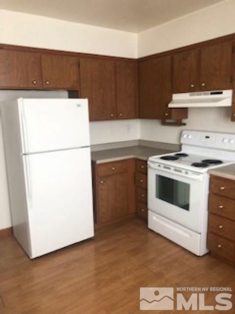 1408 East 9th Street, Unit 2 Reno, NV 89512 - Photo 3 of 10 a kitchen with a stove a refrigerator and a sink