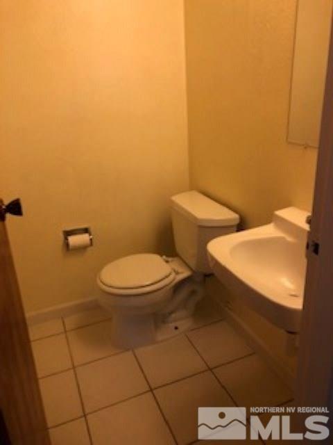 1408 East 9th Street, Unit 2 Reno, NV 89512 - Photo 7 of 10 a white toilet sitting next to a white wall