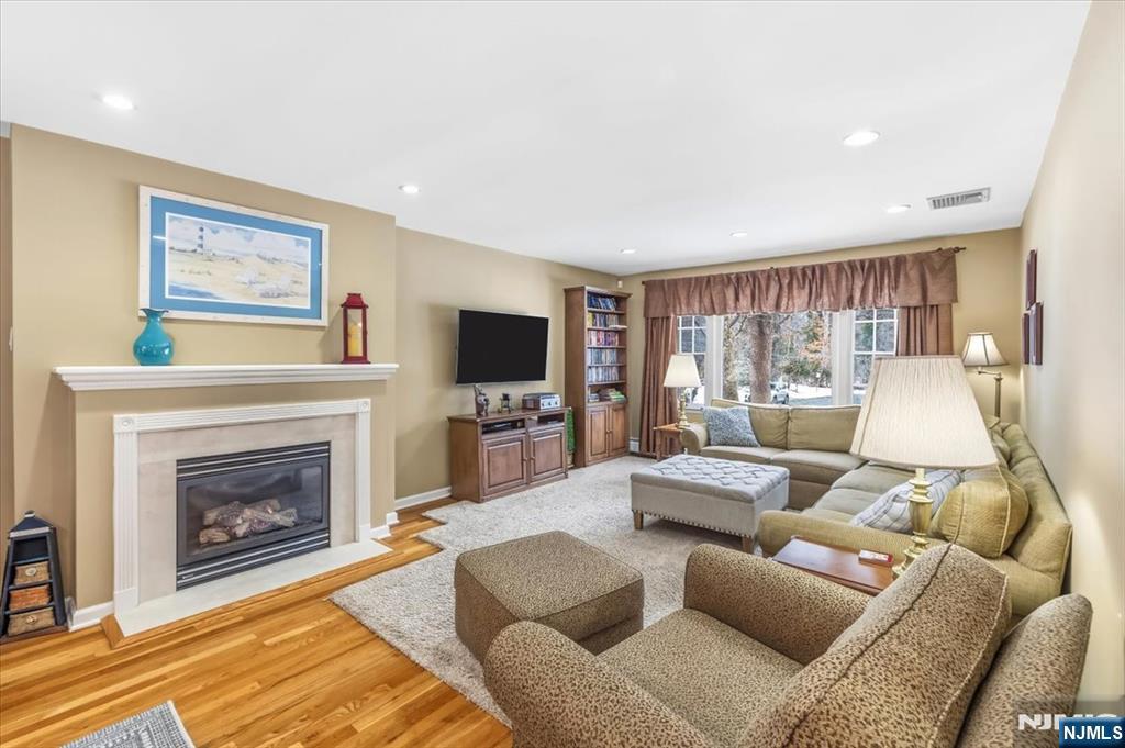 4 Lindeman Avenue Closter, NJ 07624 - Photo 11 of 36 a living room with furniture a flat screen tv and a fireplace