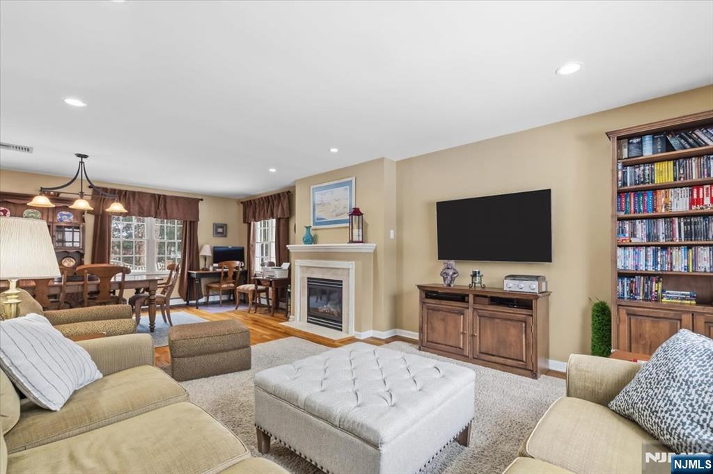 4 Lindeman Avenue Closter, NJ 07624 - Photo 12 of 36 a living room with furniture a flat screen tv and a fireplace
