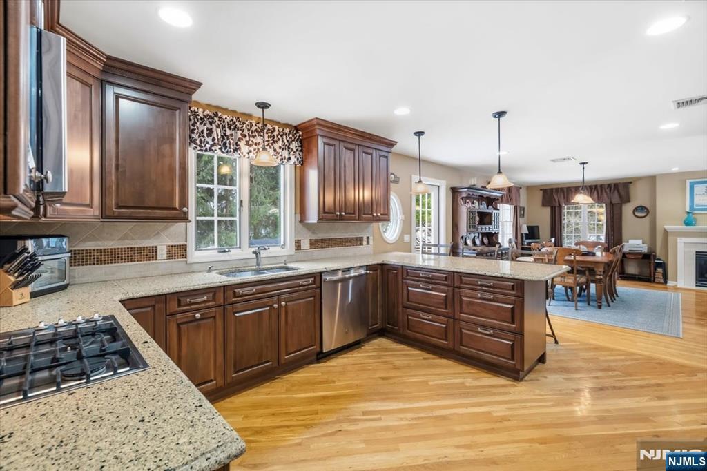 4 Lindeman Avenue Closter, NJ 07624 - Photo 15 of 36 a large kitchen with stainless steel appliances granite countertop a stove and a sink with cabinets
