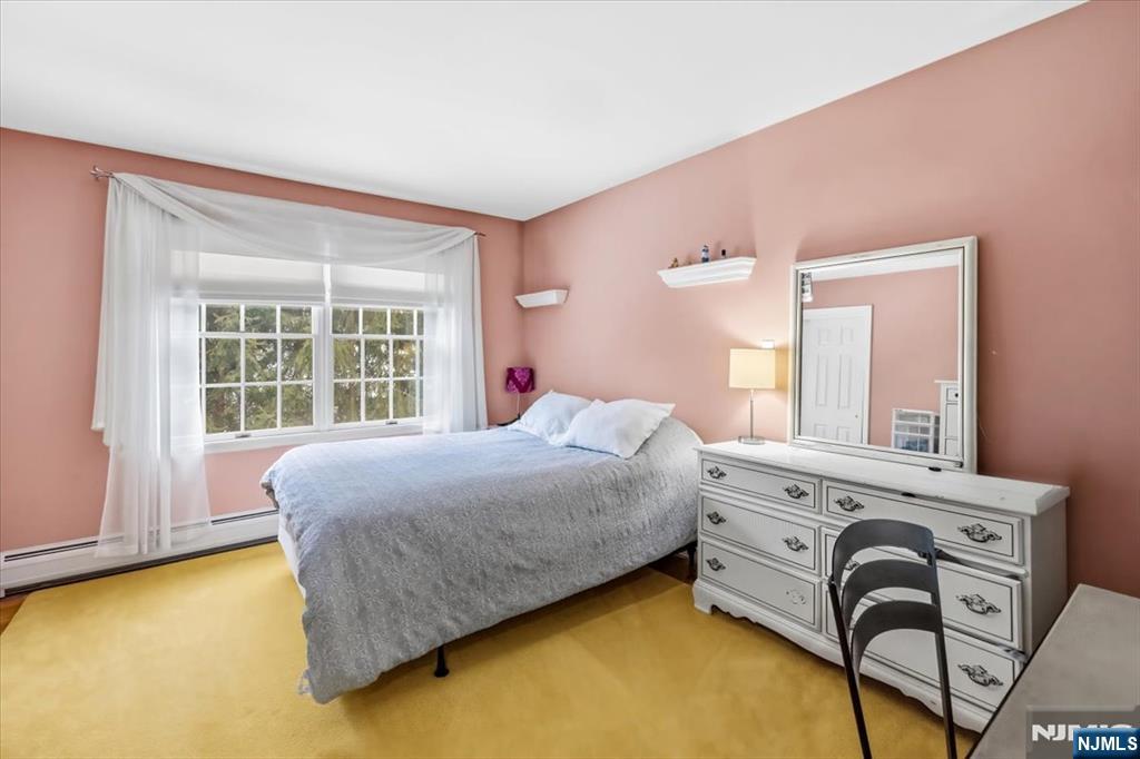 4 Lindeman Avenue Closter, NJ 07624 - Photo 22 of 36 a bedroom with a bed and a table with chair