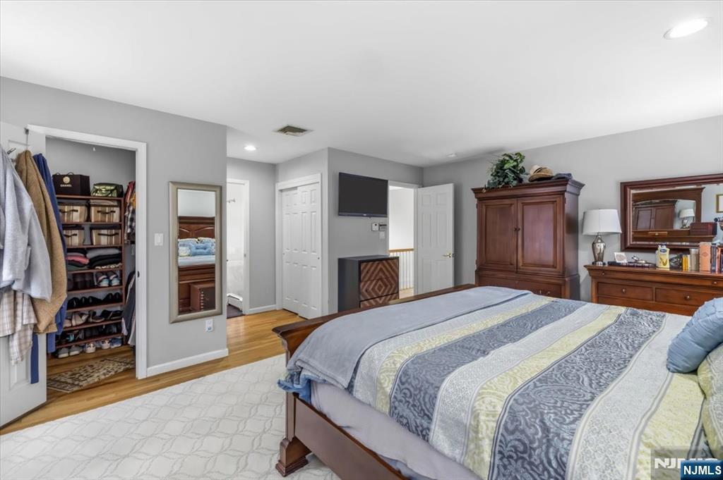 4 Lindeman Avenue Closter, NJ 07624 - Photo 26 of 36 a bedroom with a large bed and a television