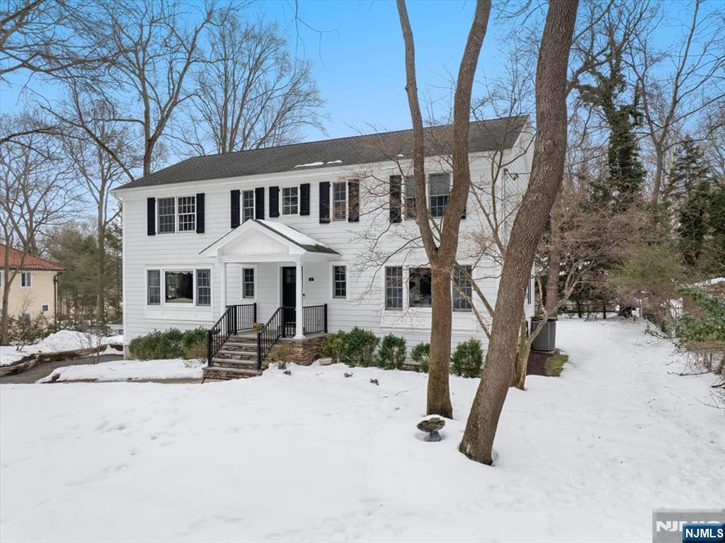4 Lindeman Avenue Closter, NJ 07624 - Photo 3 of 36 a view of a white house with a yard covered in snow