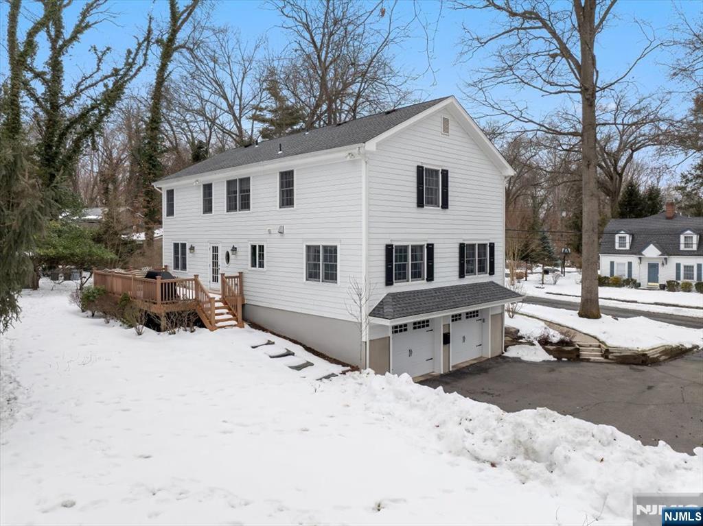 4 Lindeman Avenue Closter, NJ 07624 - Photo 31 of 36 a front view of a house with a yard covered in snow