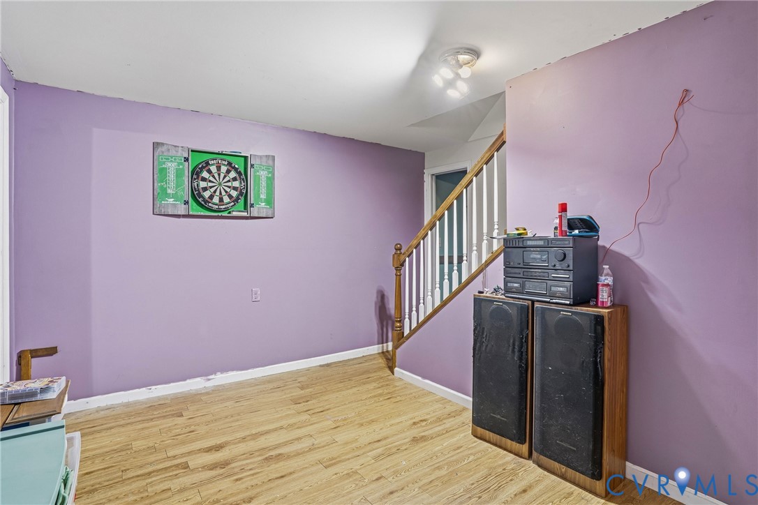 14219 Spruce Avenue Chester, VA 23836 - Photo 23 of 32 a view of a hallway with wooden floor and staircase