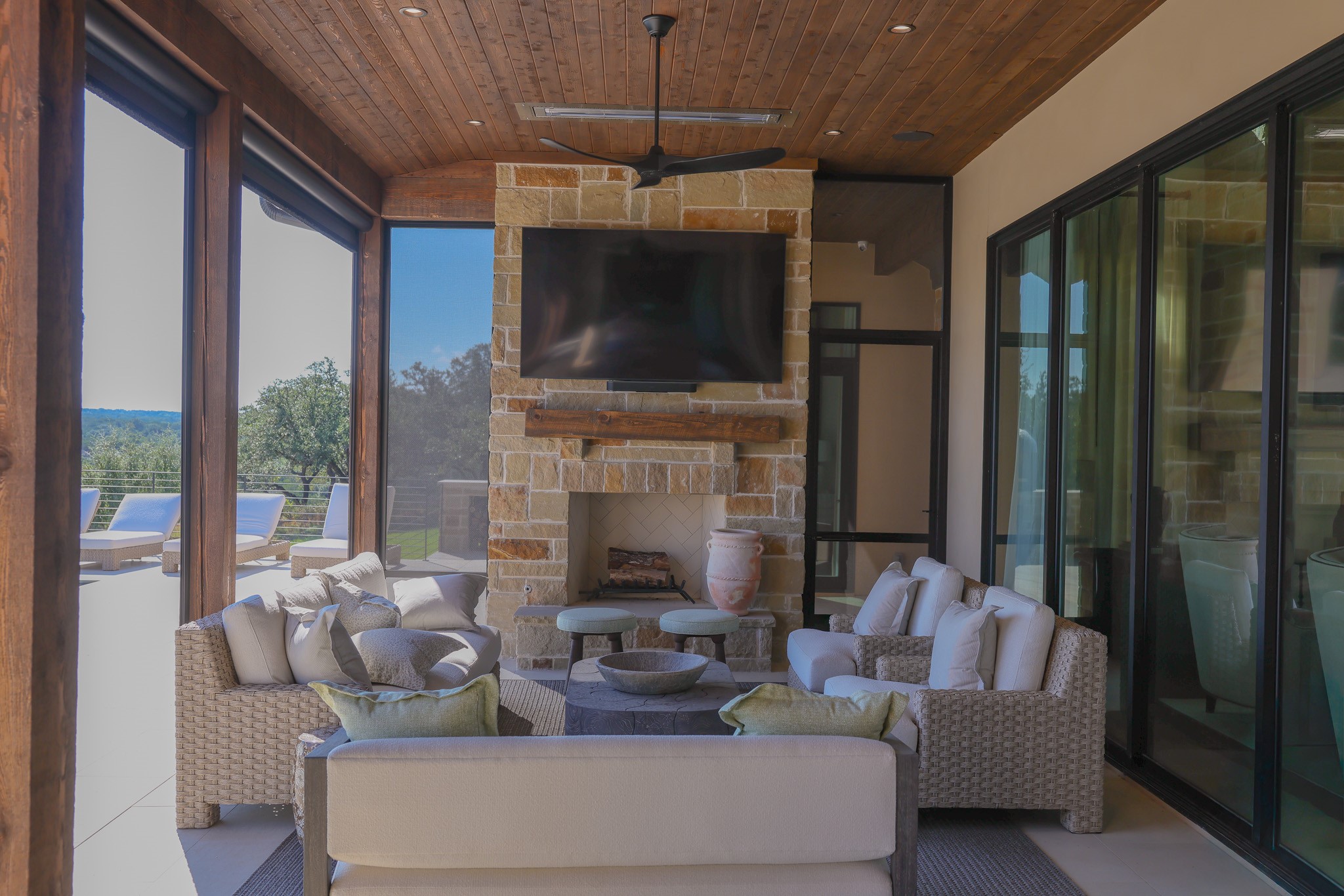 920 Ryan Road Bertram, TX 78605 - Photo 16 of 40 Rich wood plank ceilings and a stone fireplace anchor this inviting covered outdoor living area.