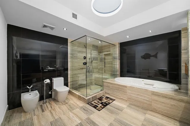 a bathroom with a bathtub shower sink and toilet