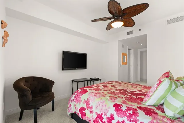 a bedroom with a bed and a television