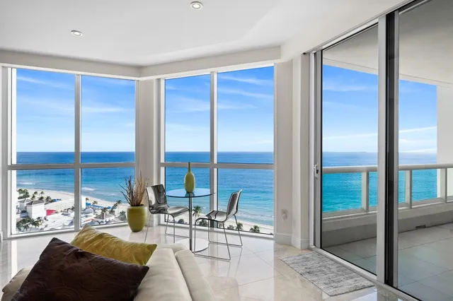 a view of a livingroom with furniture and floor to ceiling window